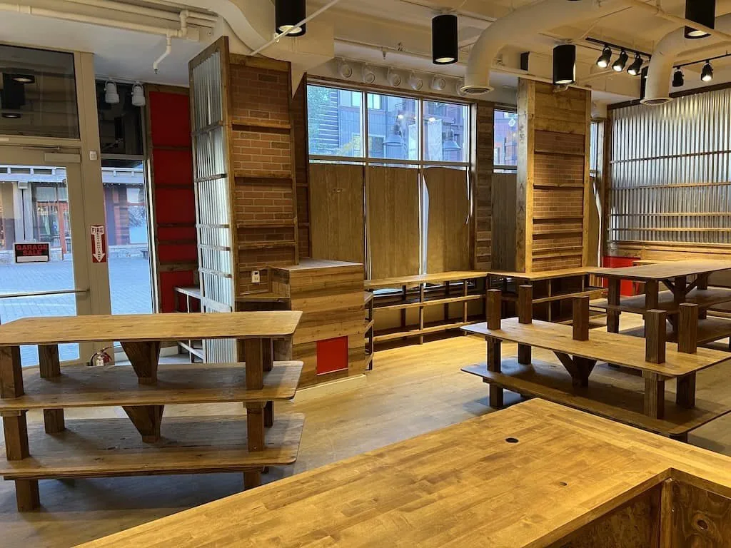 Retail interior with custom wood tables and shelving built into a resort storefront.