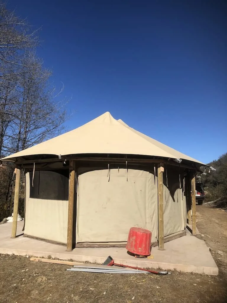 Finished yurt on a poured pad in the hills, built by Tri Peak Construction & Design, Inc.